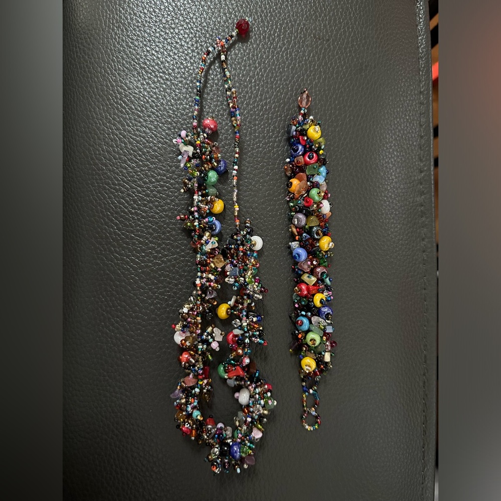 Vintage multi colored necklace and bracelet set. Looks hand made very colorful!